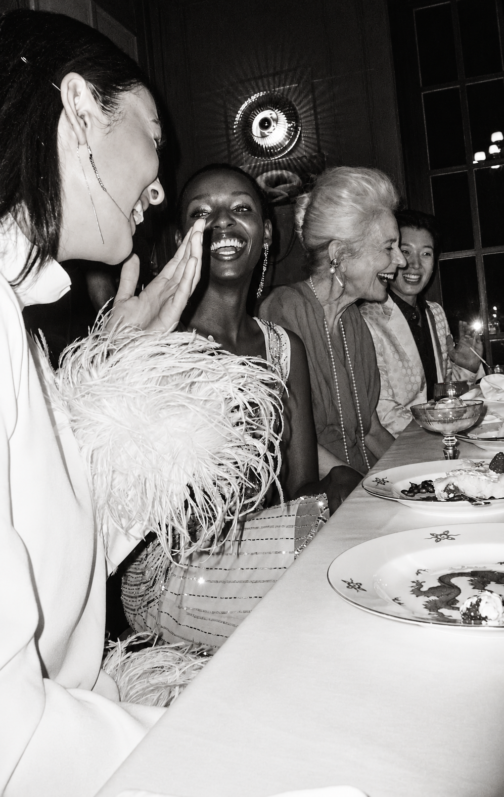 Women enjoying a candlelit private dinner — illustrative Society photography